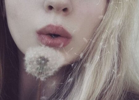 woman-blowing-a-dandelion-450x325