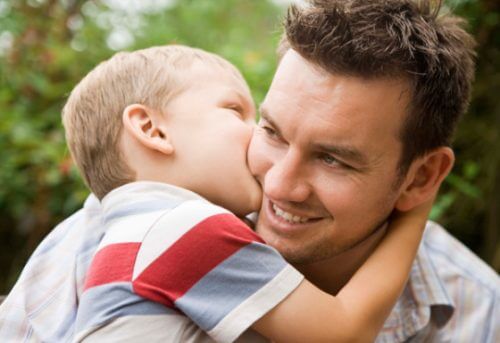 boy kissing dad