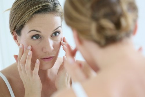woman looking into mirror