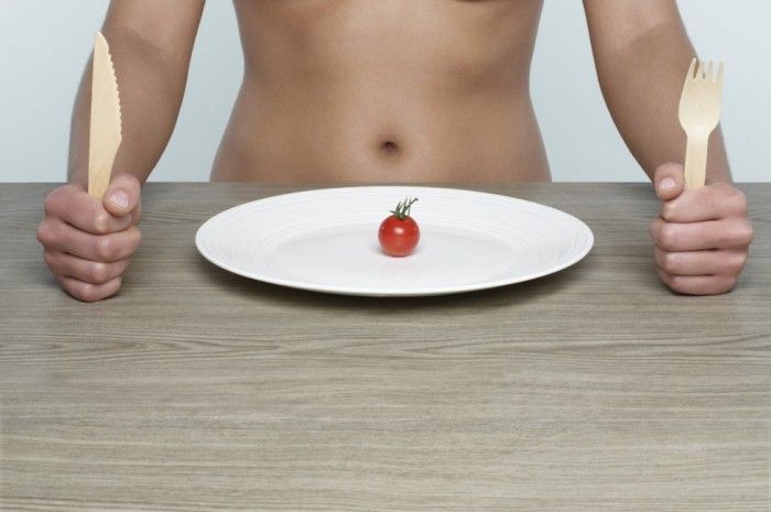 ミニトマト1個を食べる女性
