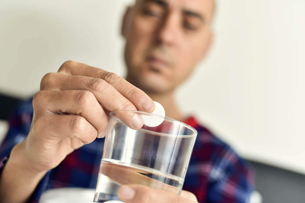 薬を見つめる男性