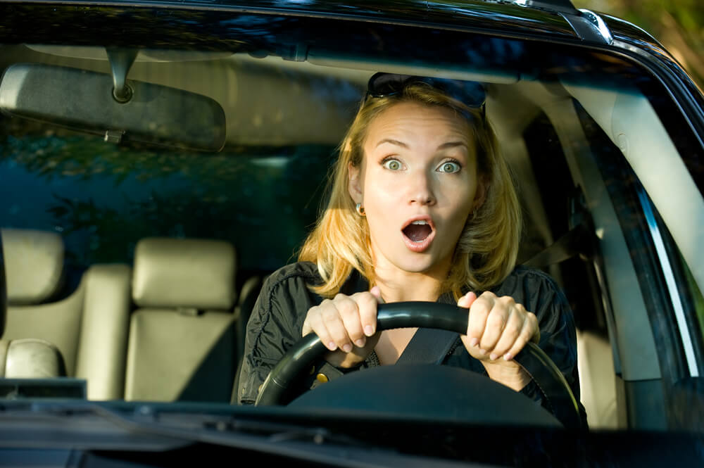 運転席で驚く女性